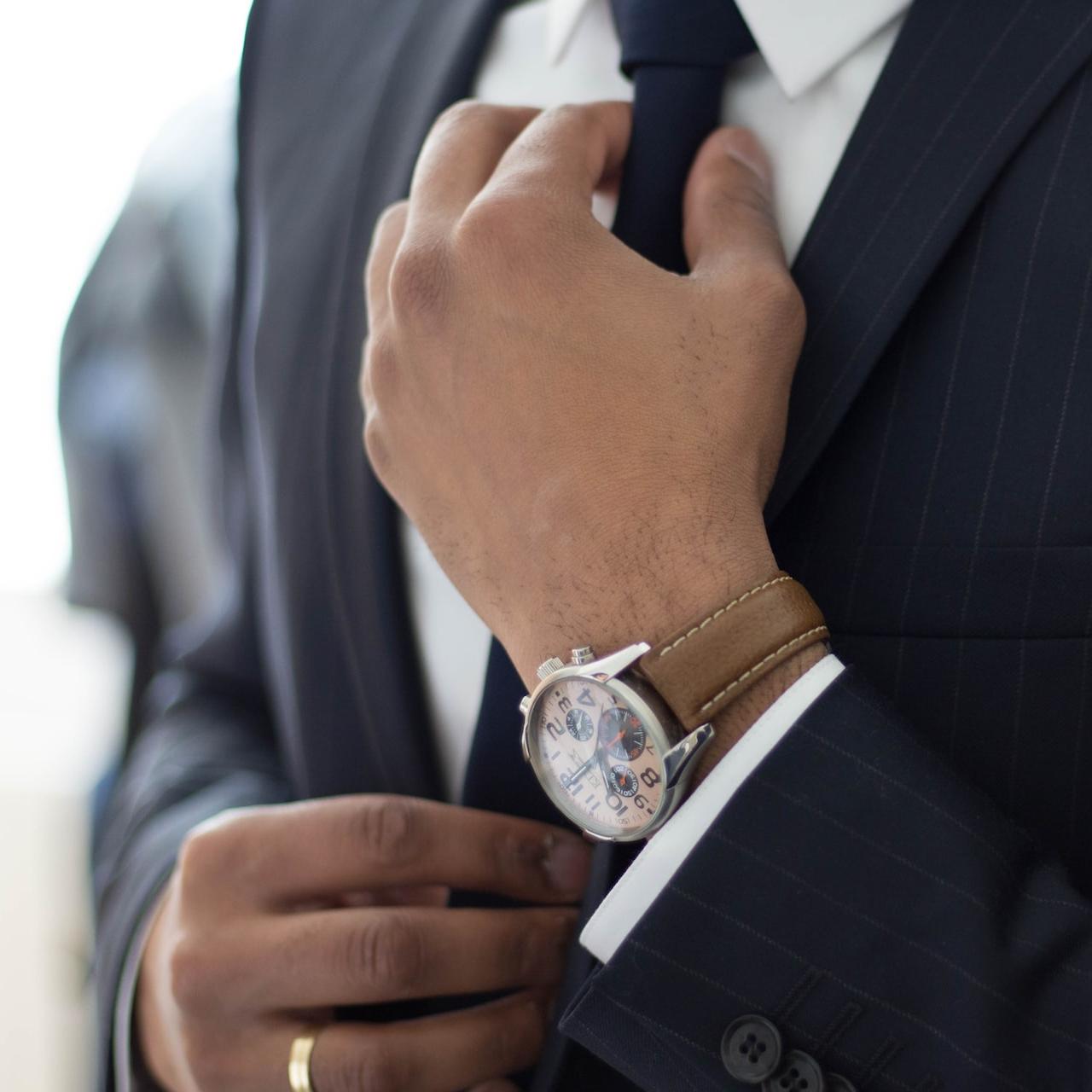 man wearing watch with black suit
